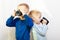 Two boys kids drinking drink from mugs