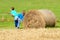 Two Boys Moving Bale of Hay