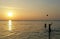 Two boys plaing ball on the sea