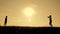 Two boys play with a wooden plane at sunset. Silhouette of children playing with an airplane. Dreams of flying. Children