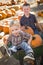 Two Boys Playing in Wheelbarrow at the Pumpkin Patch