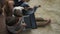 Two boys plays on laptop sitting on carpet at home