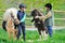 Two boys with ponies