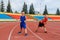 Two boys are preparing for the start of a sports race at the stadium. one hundred meters