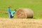 Two Boys Pushing Bale of Hay