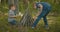 Two boys put sticks in a fire in the woods during a hike. Boys in the woods prepare to light a fire and put sticks