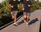 Two boys running side by side on boardwalk by Fire Island Lighthouse