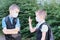 Two boys, schoolchildren in white medical masks on their faces talking to each other, brothers or friends, the concept of studying