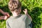 Two boys searchin green grass under bright sun