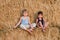 Two boys sit on the big barn