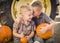 Two Boys Sitting Against Tractor Tire Holding Pumpkins Whispering Secrets