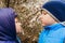 Two boys sniffing cherry blossoms in the spring