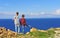 Two boys standing on cliffs by the sea
