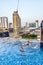 Two boys swim in a rooftop pool