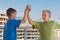 Two boys in T-shirts are greet each other