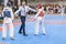 Two boys in the Taekwondo outfit of blue and red color are fighting at doyang
