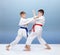 Two boys are trained blocks and punches in karategi