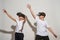 Two boys using virtual reality headset on white