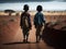 two boys walking on a dirt road in the middle of an african desert