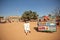 Two boys walking past dusty street