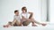 two boys in white T-shirts pose for a photographer in a photo studio.