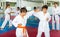 Two boys working in pair, mastering new karate moves in class closeup