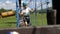 Two brave boys pass obstacles one after another in a rope park in the summer.