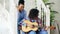 Two brazilian curly girls sistres sitting on stairs and practice to play acoustic guitar. Friends have fun and singing