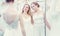 Two brides same sex wedding couple looking at dress mannequin
