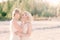 Two brides women in white dress with blonde hair hugging each other
