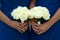 Two bridesmaids hold wedding bouquets