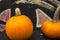 Two bright pumpkins on the stump, autumn background