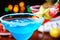 Two bright refreshing cocktails: blue margarita and strawberry daiquiri.