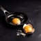 Two broken chicken eggs on a black background. Cooking scrambled eggs. Backdrop. AI generated