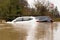Two Broken Down Cars Submerged In a flooded Ford / River. UK