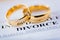 Two broken golden wedding rings divorce decree document