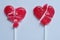 Two broken red heart lollipops symbolizing broken hearts