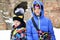 Two brother boys warmly dressed in jackets and hats and a hood with a bag on his shoulder look seriously on a walk on vacation