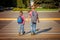 Two brothers with backpack walking, holding on warm day on the