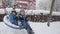 Two brothers happily playing on a snowy swing set at the public playground. Winter fun, family bonding, and outdoor activity.