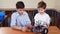 Two brothers kids playing with robot toy at school robotics class, indoor.