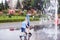 Two brothers are playing in a fountain