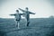 Two brothers running together on meadow, sepia toned