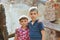 Two brothers stand near the ruined house, the concept of natural disaster, fire, and devastation.