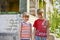 Two brothers are standing near a burned-out house, who lost their homes as a result of hostilities and natural disasters