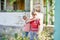 Two brothers are standing near a burned-out house, who lost their homes as a result of hostilities and natural disasters