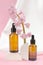 Two brown bottles with a dropper with essential oils or serum with hyacinth flowers. Care and beauty concept