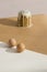 Two brown chicken eggs and traditional exquisite Easter cake on trendy isometric beige background. The minimalism of an Easter