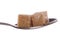 Two brown demerara sugar cube on a tea spoon