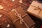 Two brown gift boxes on a wooden background with a bow of a simple rope on wood backgraund